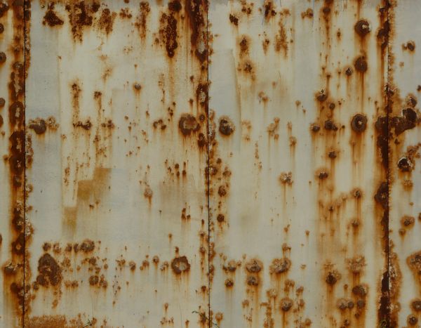 White metal texture covered by many small red spots and patches of rust.